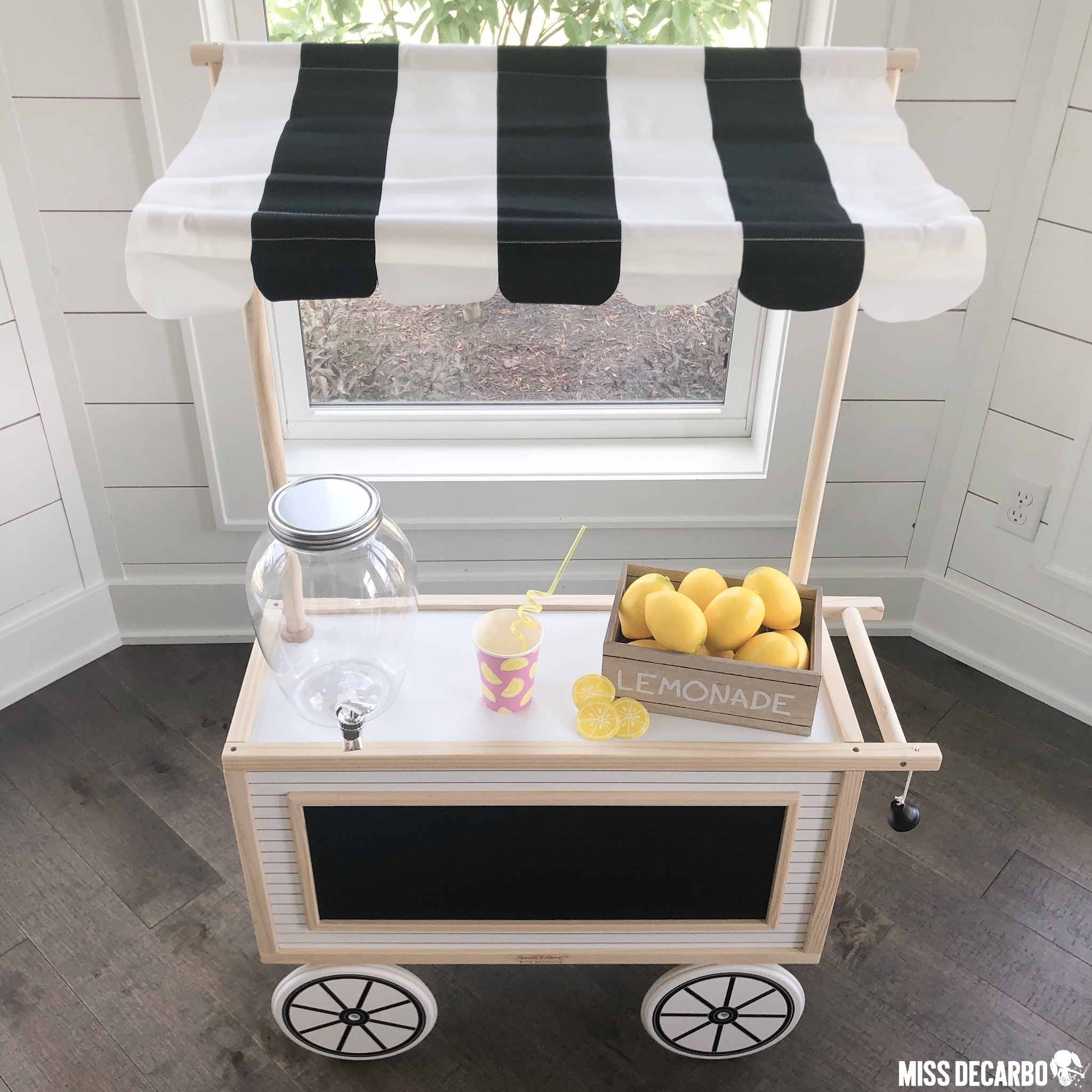 A modern farmhouse play cart that was transformed into a lemonade stand. This adorable dramatic play cart is perfect for fostering pretend-play and imagination!