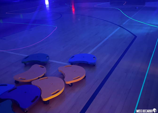 Use glow-in-the-dark tape to create a glow track in the gym with scooters during literacy night!